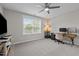Bright bedroom featuring a ceiling fan, desk area, and a window that provides natural light at 4420 Bonnie Loch Dr, Burlington, NC 27215