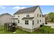 An aerial rear exterior view of a two-story home with a wooden deck and fenced in yard at 4420 Bonnie Loch Dr, Burlington, NC 27215