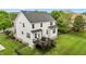 Rear aerial view of the property, showcasing the wooden deck, fenced yard, and manicured lawn at 4420 Bonnie Loch Dr, Burlington, NC 27215