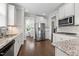 Bright kitchen boasts stainless steel appliances, granite countertops, and a view of the dining room at 4420 Bonnie Loch Dr, Burlington, NC 27215