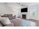 Inviting living room with fireplace, large TV, and stylish blue patterned rug at 4420 Bonnie Loch Dr, Burlington, NC 27215