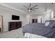 Spacious main bedroom features a ceiling fan, large windows, and a dark wood dresser at 4420 Bonnie Loch Dr, Burlington, NC 27215