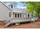 Charming backyard with deck area, gray siding and mature trees at 5 Wembley Ct, Durham, NC 27705