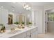 Bright bathroom with double vanity, large mirror, and glass-enclosed shower at 5 Wembley Ct, Durham, NC 27705