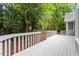 View of spacious wooden deck overlooking wooded backyard at 5 Wembley Ct, Durham, NC 27705