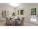 Bright dining room with a marble table, comfortable seating, and access to the backyard at 5 Wembley Ct, Durham, NC 27705