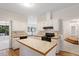 Spacious kitchen with white cabinets, an island, and hardwood floors at 5 Wembley Ct, Durham, NC 27705