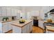 Well-lit kitchen with white cabinets, wooden countertops, an island and wood-style flooring at 5 Wembley Ct, Durham, NC 27705