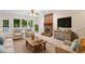 Cozy living room featuring a brick fireplace, comfortable seating, and bright natural light at 5 Wembley Ct, Durham, NC 27705