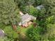 Aerial view of home with expansive backyard featuring a patio, deck, mature trees, and landscaped grounds at 5116 Knaresborough Rd, Raleigh, NC 27612