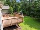 Relaxing backyard with a spacious wood deck and play set at 5116 Knaresborough Rd, Raleigh, NC 27612