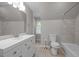 Well-lit bathroom with vanity, toilet, and tiled shower-tub combination at 5116 Knaresborough Rd, Raleigh, NC 27612
