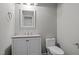 Bathroom featuring a modern vanity, toilet, and decorative mirror at 5116 Knaresborough Rd, Raleigh, NC 27612