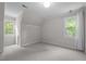 Upstairs bedroom with multiple windows and neutral carpeting at 5116 Knaresborough Rd, Raleigh, NC 27612
