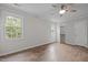 Well-lit bedroom with hardwood floors, windows, and a ceiling fan at 5116 Knaresborough Rd, Raleigh, NC 27612