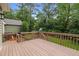 Wooden deck overlooking a spacious backyard with playground equipment at 5116 Knaresborough Rd, Raleigh, NC 27612