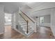 Bright entryway with hardwood floors, staircase, and views into the living and kitchen at 5116 Knaresborough Rd, Raleigh, NC 27612