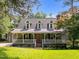Charming home with a welcoming front porch, dormer windows, and well-manicured lawn at 5116 Knaresborough Rd, Raleigh, NC 27612