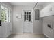 Laundry room with tile floor, a door to outside and lots of storage at 5116 Knaresborough Rd, Raleigh, NC 27612