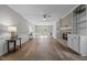 Open-concept living room with fireplace, hardwood floors, and natural light at 5116 Knaresborough Rd, Raleigh, NC 27612