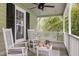Cozy covered porch with rocking chairs and a porch swing provides a relaxing outdoor space at 5116 Knaresborough Rd, Raleigh, NC 27612