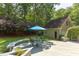 Backyard boasts a wooden deck with outdoor seating under a turquoise umbrella, set in a lush green lawn at 520 Brittany Bay W, Raleigh, NC 27614