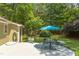 Backyard features a deck with outdoor seating and a blue umbrella, surrounded by a well-manicured lawn and trees at 520 Brittany Bay W, Raleigh, NC 27614
