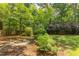 Tranquil backyard setting with a fire pit and landscaped garden, perfect for unwinding at 520 Brittany Bay W, Raleigh, NC 27614