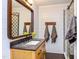 Bathroom features wood-framed mirror, white shiplap walls, vanity and shower with patterned tile at 520 Brittany Bay W, Raleigh, NC 27614