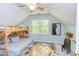 Bright bedroom features a twin bunk bed, light blue walls, and an abstract rug, filled with natural light at 520 Brittany Bay W, Raleigh, NC 27614