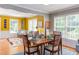 Dining room features wood floors, large windows, and a decorative table setting in a sunny setting at 520 Brittany Bay W, Raleigh, NC 27614