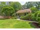 View of a charming single-Gathering home surrounded by lush green trees, with a well-maintained lawn and a inviting walkway at 520 Brittany Bay W, Raleigh, NC 27614