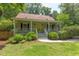Charming front exterior view of a quaint home, featuring a well-manicured lawn and covered front porch with yellow door at 520 Brittany Bay W, Raleigh, NC 27614