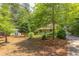 Charming home with manicured front yard, mature trees, and detached garage at 520 Brittany Bay W, Raleigh, NC 27614