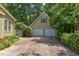 Detached two-car garage with a concrete driveway, complemented by surrounding greenery at 520 Brittany Bay W, Raleigh, NC 27614