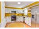 A well-lit kitchen features white cabinets, modern stainless steel appliances, and neutral countertops at 520 Brittany Bay W, Raleigh, NC 27614