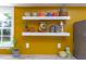 Kitchen decor features decorative dishware and collectibles displayed on floating shelves at 520 Brittany Bay W, Raleigh, NC 27614
