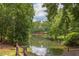 Scenic lake view framed by lush trees, creating a serene and natural environment for residents to enjoy at 520 Brittany Bay W, Raleigh, NC 27614