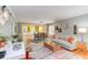 Bright and open living room featuring hardwood floors, stylish furniture, and an inviting view of the adjacent dining area at 520 Brittany Bay W, Raleigh, NC 27614