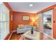 Comfortable living area with vibrant wall color, barn door to bedroom, patterned furniture and hardwood floors at 520 Brittany Bay W, Raleigh, NC 27614