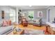 Comfortable living room featuring hardwood floors, gray walls, stylish seating, and views of the lush outdoors at 520 Brittany Bay W, Raleigh, NC 27614
