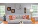 Comfortable living room with hardwood floors, a stylish sofa, and natural light from the windows at 520 Brittany Bay W, Raleigh, NC 27614