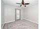 Bright bedroom with a fan, carpeting, neutral walls and a private door to the exterior at 520 Camden Yards Way, Cary, NC 27519