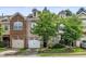 Beautiful townhouse with a two-car garage and manicured lawn at 520 Camden Yards Way, Cary, NC 27519