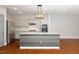 This kitchen features a center island, stainless steel appliances, granite countertops, and wood flooring at 520 Camden Yards Way, Cary, NC 27519