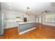 This kitchen features a center island, stainless steel appliances, granite countertops, and wood flooring at 520 Camden Yards Way, Cary, NC 27519