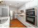 This kitchen features stainless steel appliances, granite countertops, and wood flooring at 520 Camden Yards Way, Cary, NC 27519