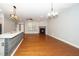 Open floor plan features a kitchen island, living room with fireplace, and hardwood floors at 520 Camden Yards Way, Cary, NC 27519