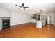 Open living room featuring a fireplace, kitchen, and stairway at 520 Camden Yards Way, Cary, NC 27519