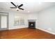 Living room with hardwood floors, fireplace, fan, and access to patio at 520 Camden Yards Way, Cary, NC 27519